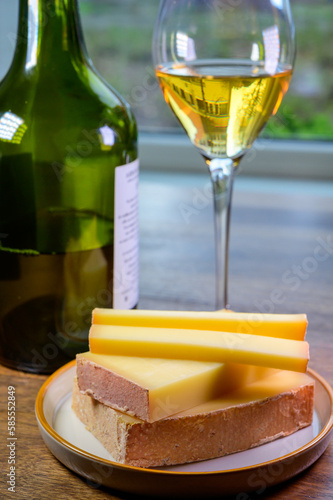 Fotografie Wine and cheese pairing, local Comte cheese produced in the Franche-Comté region