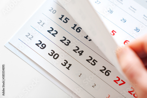 Photography flipping through the pages of the flip calendar.
