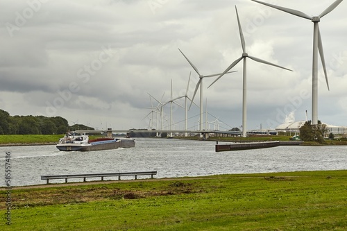 Wind tubines along the waterside photo