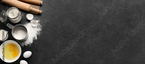 Fotografía Different ingredients for baking on dark background with space for text