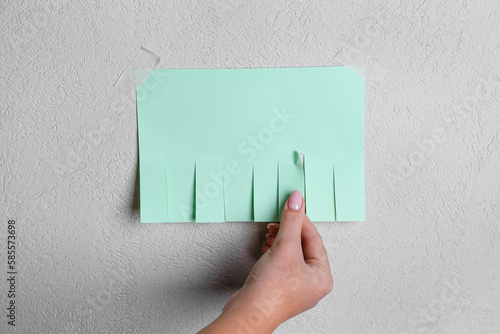 Quadro em tela Woman tearing off paper ad from light wall