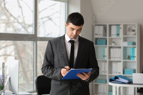 Young accountant with docum...