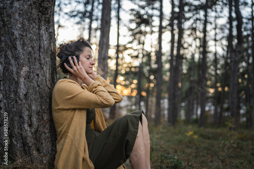 one woman in park or forest online guided meditation self-care concept