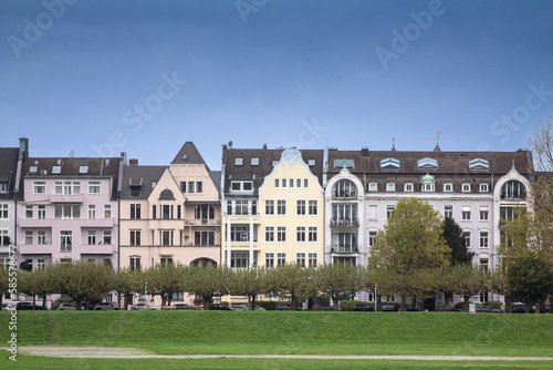 Typical residetial street with multistorey residential buildings in Oberkassel, a suburban street of Dusseldorf, germany, on the waterfront in a Western European background.