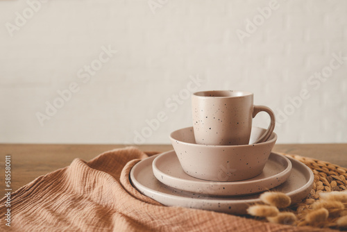 Stylish set of beige dishes on a white background