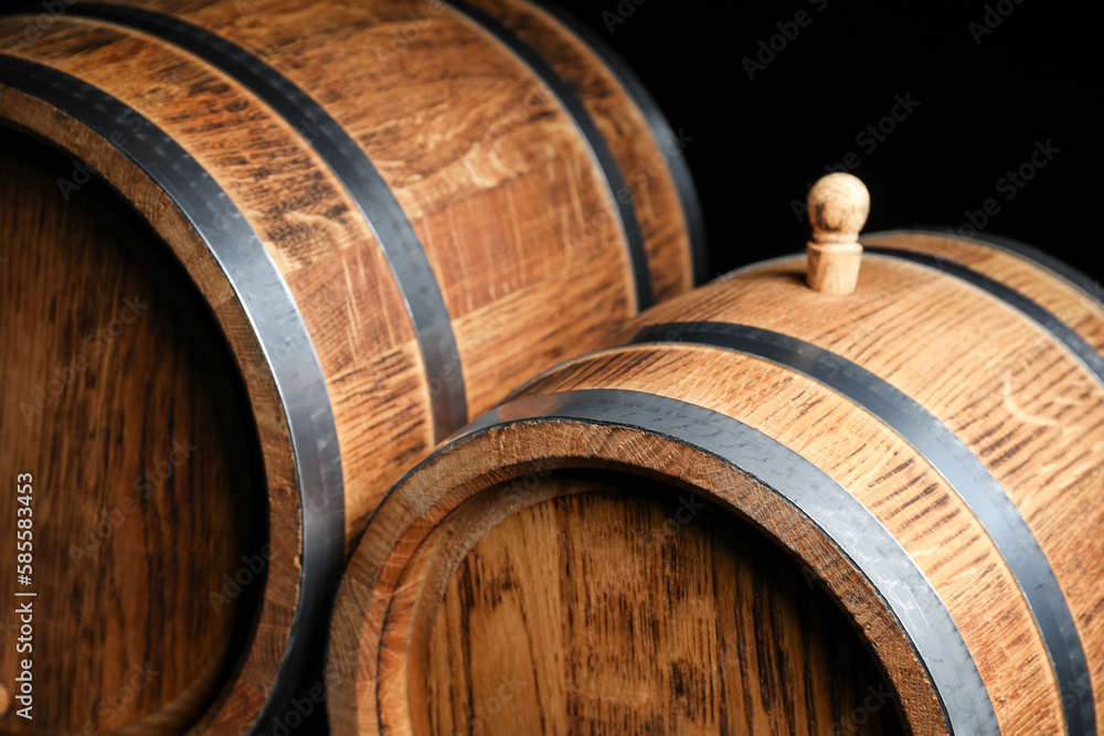 Wooden barrels on dark background, closeup Wooden barrels on dark background, closeup