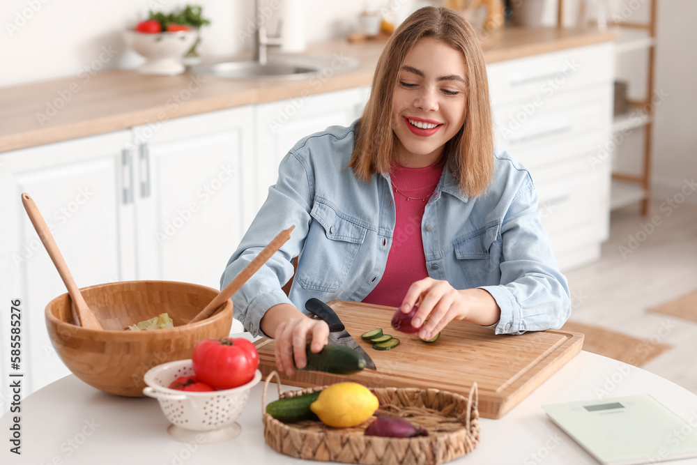 Young woman making vegetable salad in kitchen Young woman making vegetable salad in kitchen