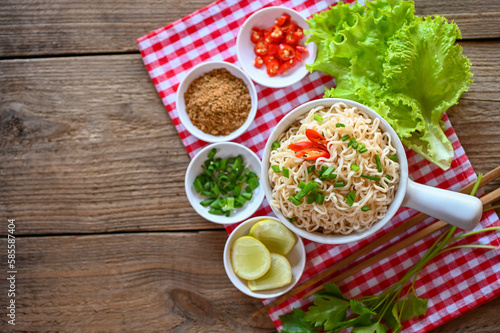 noodles bowl with vegetable spring onion lemon lime lettuce celery and chili on table food , instant noodles cooking tasty eating with bowl - noodle soup