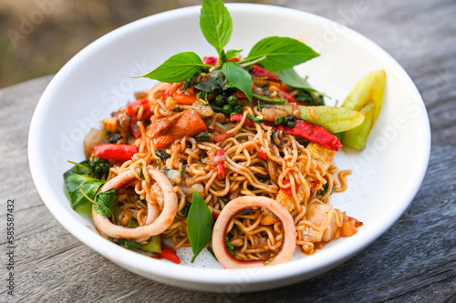 noodles plate with instant noodles stir fried with vegetables herb spicy tasty appetizing asian noodles mix seafood stir fried squid with basil and chilli pepper