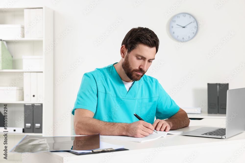 Doctor writing results from MRI scan in hospital Doctor writing results from MRI scan in hospital