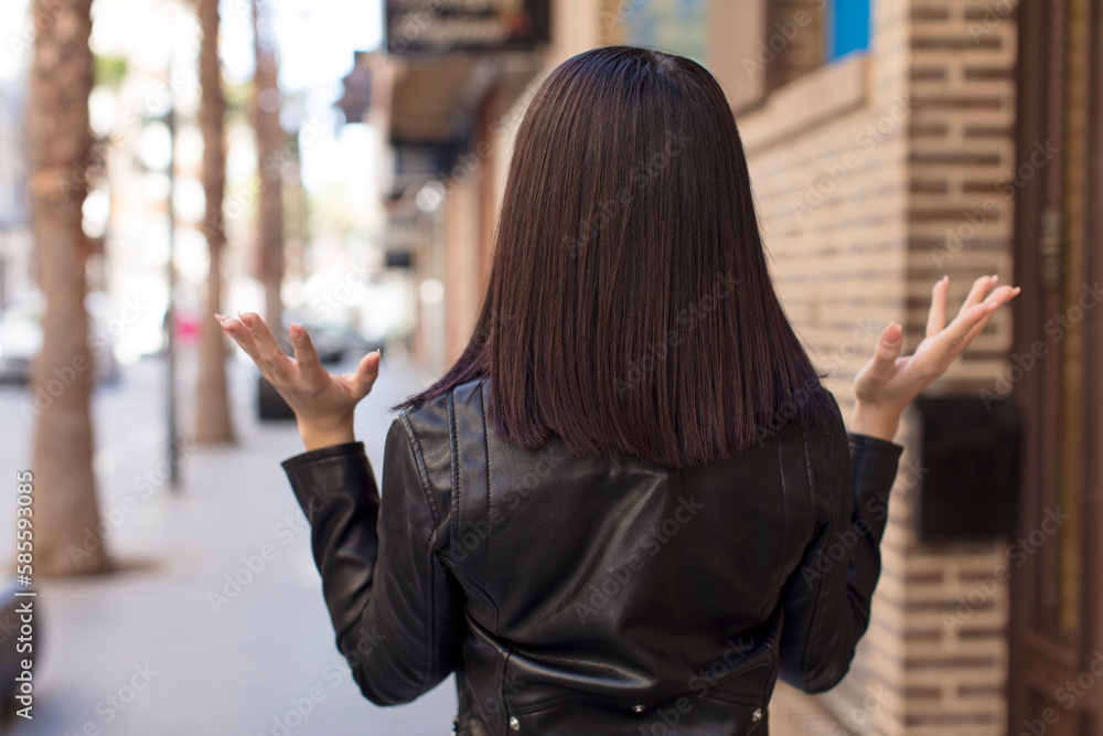 Fototapeta premium young pretty woman angry with hands up in the air, feeling furious, frustrated, stressed and upset
