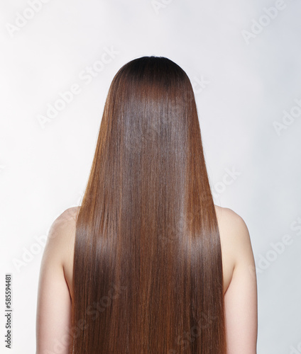 A woman from the back with very long brown hair.