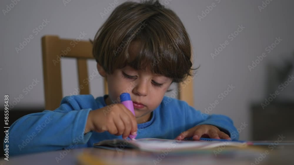 One small boy doing school activity at home wearing pajamas. Childhood creative development activity. Kid studying One small boy doing school activity at home wearing pajamas. Childhood creative development activity. Kid studying