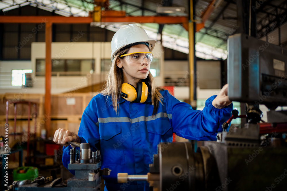 Woman worker in protective uniform operating machine at factory Industrial. Woman worker in protective uniform operating machine at factory Industrial.