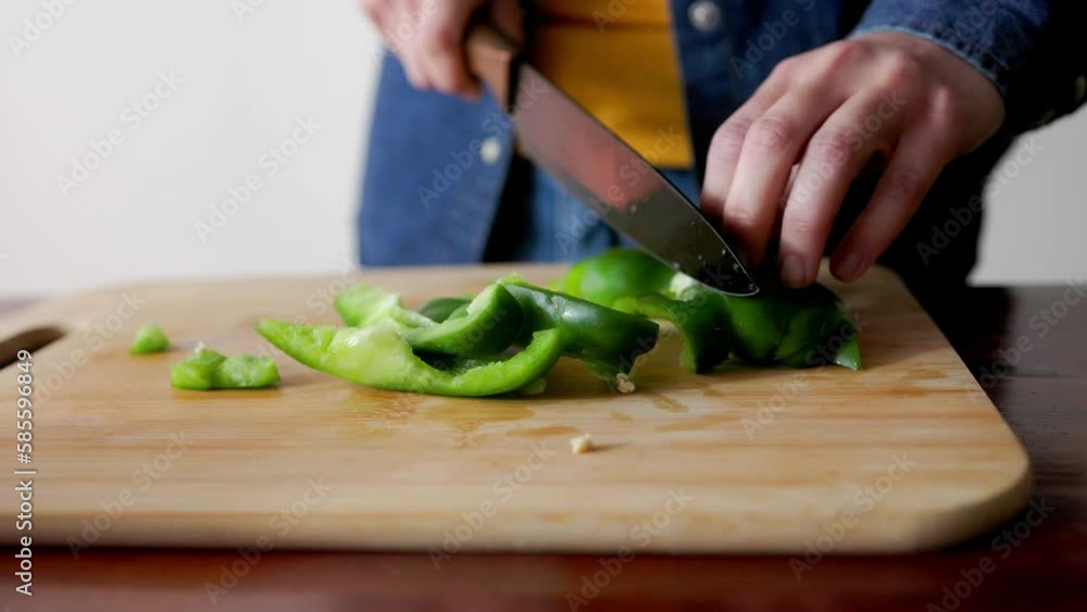 Chef woman cutting vegetable pepper for vegetarian recipe at home kitchen - Healthy food concept Chef woman cutting vegetable pepper for vegetarian recipe at home kitchen - Healthy food concept