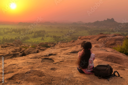 Female tourist enjoy aerial landscape view of Hamp at sunset at Karnataka India