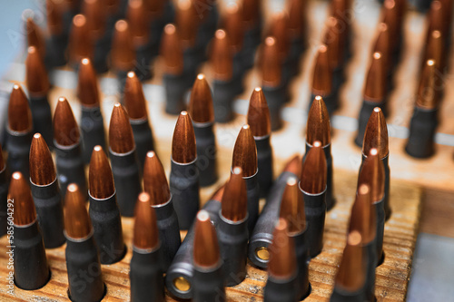 Riffle bullets in wooden racks in production plant workshop