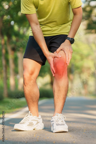 Young adult male with muscle pain during running. runner have knee ache due to Runners Knee or Patellofemoral Pain Syndrome, osteoarthritis and Patellar Tendinitis. Sports injuries and medical concept