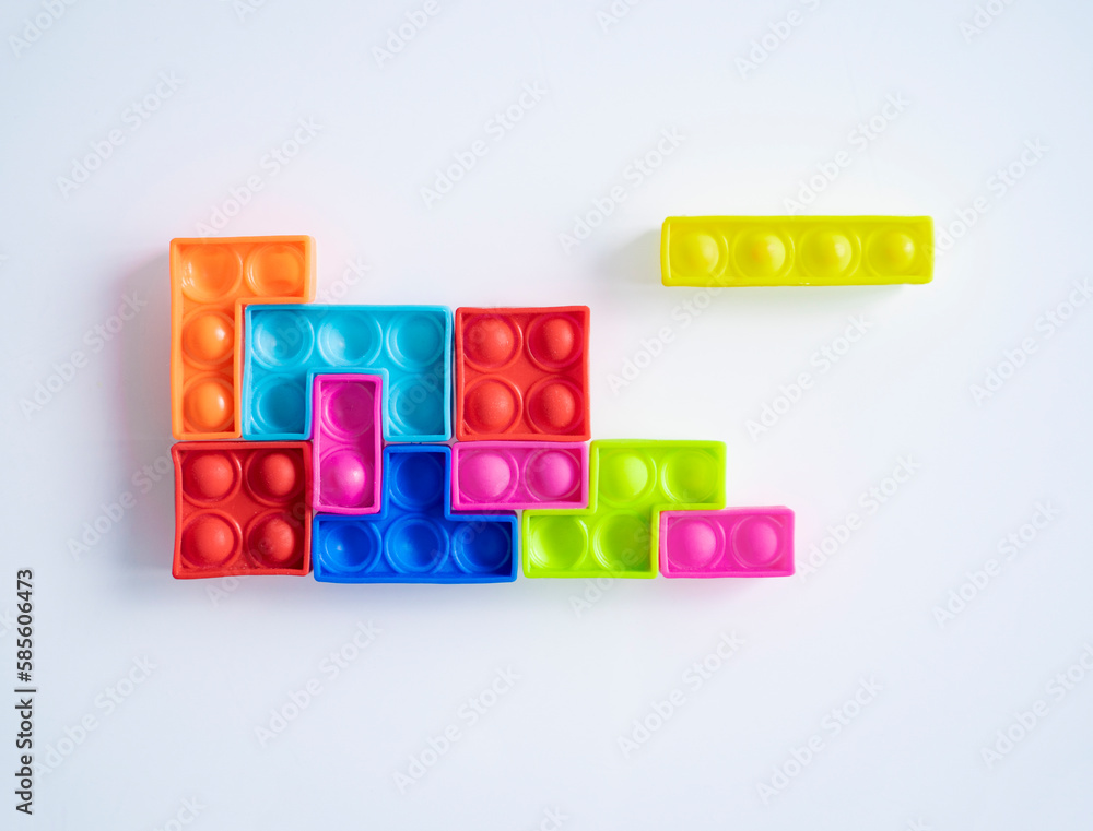 Colorful rubber toy blocks on white glass background Colorful rubber toy blocks on white glass background