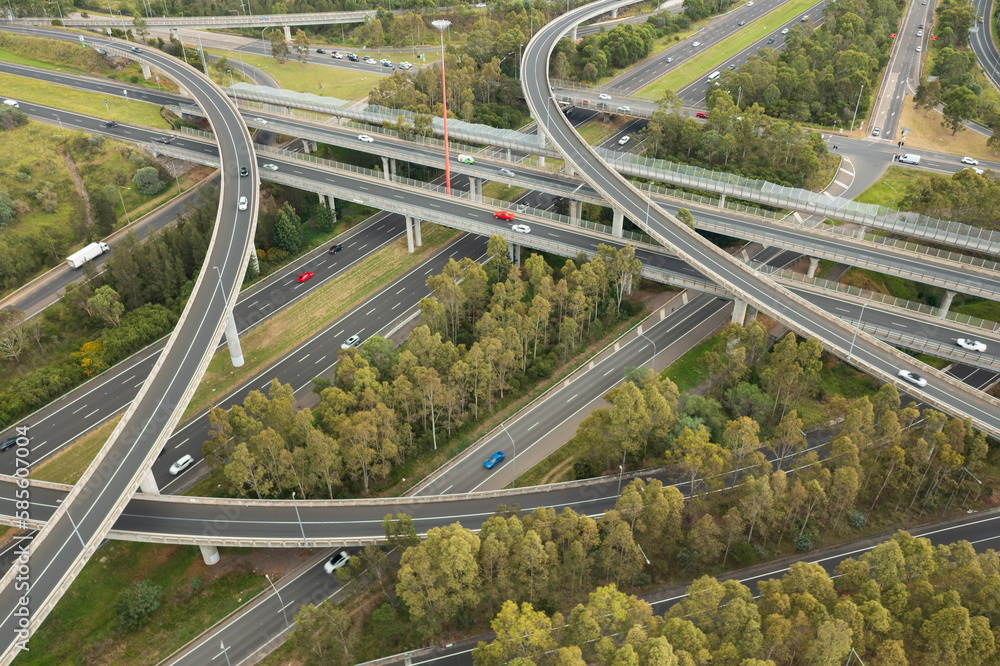 Fototapeta premium Aerial view of blurred traffic at the Light Horse Interchange junction of M4 and M7 motorways at Eastern Creek in western Sydney, Australia.