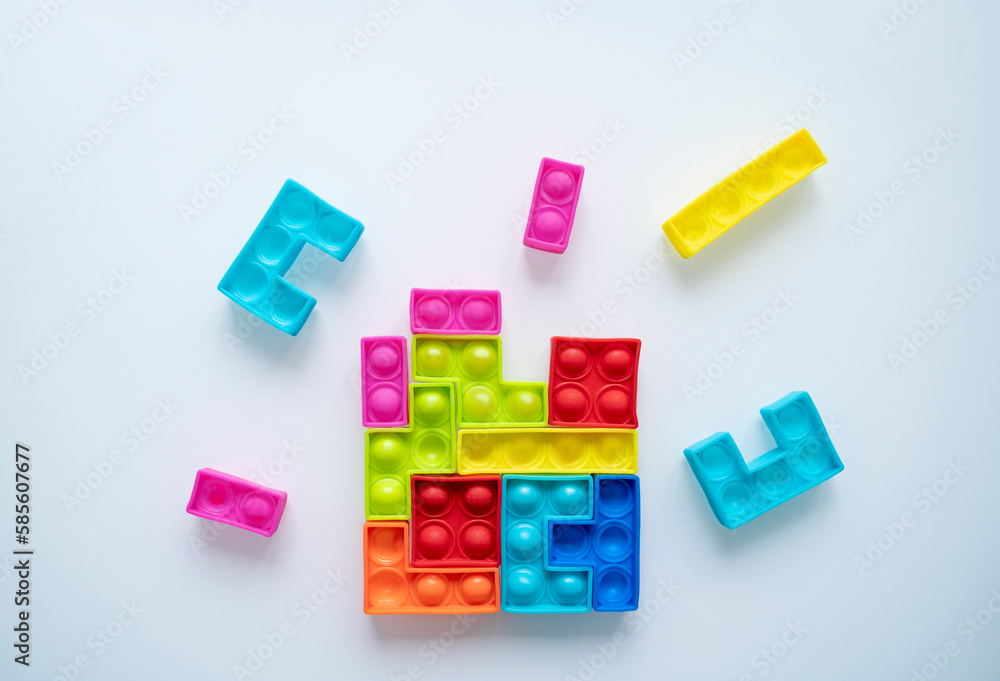 Colorful toy blocks flying around and making one whole piece Colorful toy blocks flying around and making one whole piece