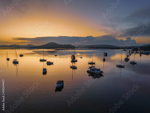 Soft and hazy aerial sunrise waterscape with boats