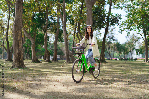 Women riding bicycle with enjoying for relaxation and exercise with healthy lifestyle in the park