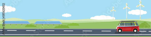 Happy family travels with van car on asphalt road for banner.  Asphalt road near the with big green hill under clear sky surrounded by green grass. Ecology technology of solar panel and windmill.