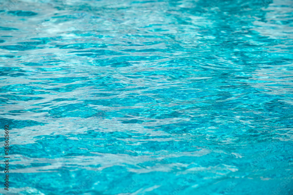 Water background, ripple waves. Blue swiming pool pattern. Sea surface. Water in swimming pool with sun reflection. Banner with copy space. Water background, ripple waves. Blue swiming pool pattern. Sea surface. Water in swimming pool with sun reflection. Banner with copy space.