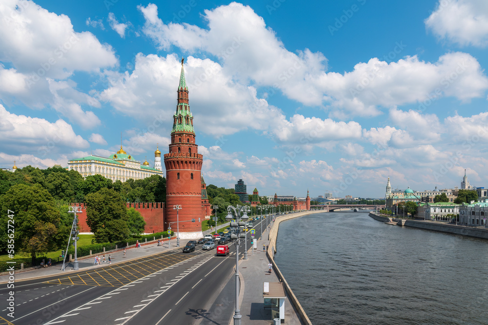 View of Kremlin with Vodovzvodnaya tower, Grand Kremlin Palace from repaired Bolshoy Kamenny Bridgein Moscow city on sunny summer day View of Kremlin with Vodovzvodnaya tower, Grand Kremlin Palace from repaired Bolshoy Kamenny Bridgein Moscow city on sunny summer day