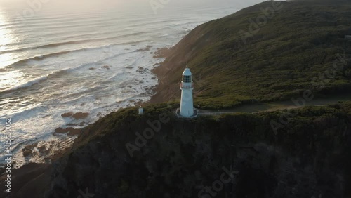 An aerial top down sunset shot of Cape Otway lighthouse, along the coastline, Abollo Bay, Australia