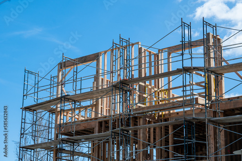 Multi-dwelling apartment building construction with framing and scaffolding