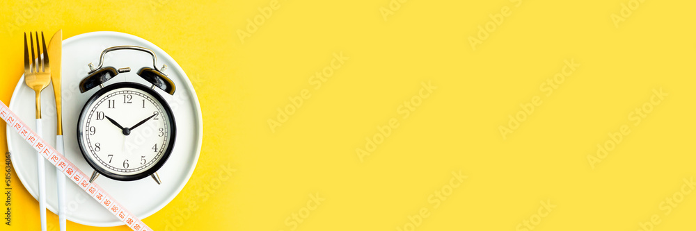 Minimal macro photography of measuring tape on fork and knife on yellow background with copy space. Mockup template for diet and meal plan Minimal macro photography of measuring tape on fork and knife on yellow background with copy space. Mockup template for diet and meal plan