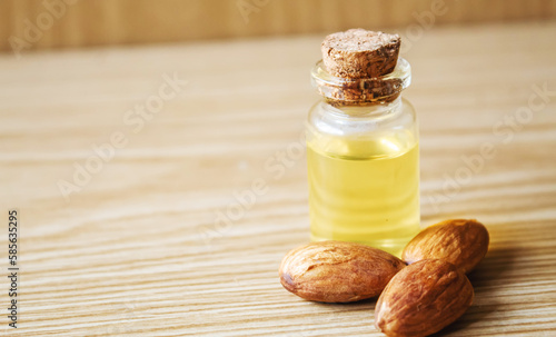 Almond essential oil in a small bottle. Selective focus.