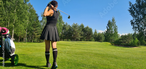 Woman golf player plays golf on golf course