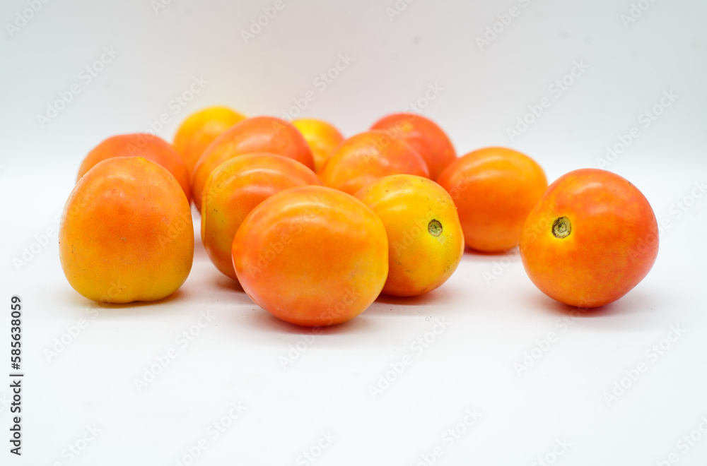 Pile of tomatoes on white background