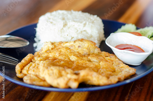 Minced pork omelet on wooden table, side view