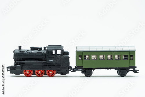 Locomotive and green toy wagon of train on a white background