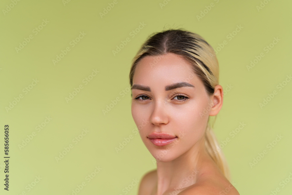 Beauty portrait of young topless woman with bare shoulders on green background with perfect skin and natural makeup Beauty portrait of young topless woman with bare shoulders on green background with perfect skin and natural makeup