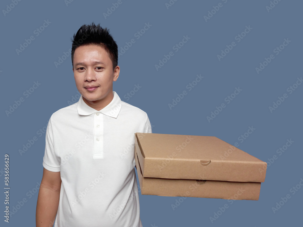 Man holding cardboard pizza box with one hand isolated on plain background. Man holding cardboard pizza box with one hand isolated on plain background.