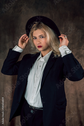 Portrait of a beautiful Caucasian business woman in a modest suit on a single background