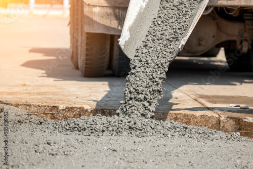 Pouring ready-mixed concrete after placing steel reinforcement to make the road by mixing in construction site	
