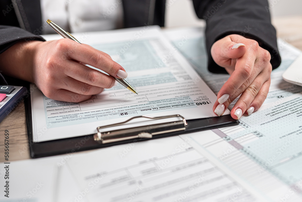 woman working with business report document , filling tax form, accounting woman working with business report document , filling tax form, accounting