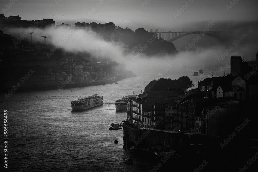 View of the Douro river in old city center in the fog, Porto, Portugal. Black and white photo.