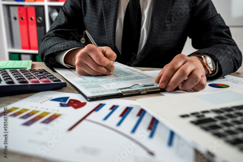 young businessman filling annual 1040 tax form business individual income