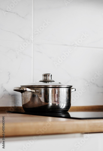 Metal pot on induction cooker. k