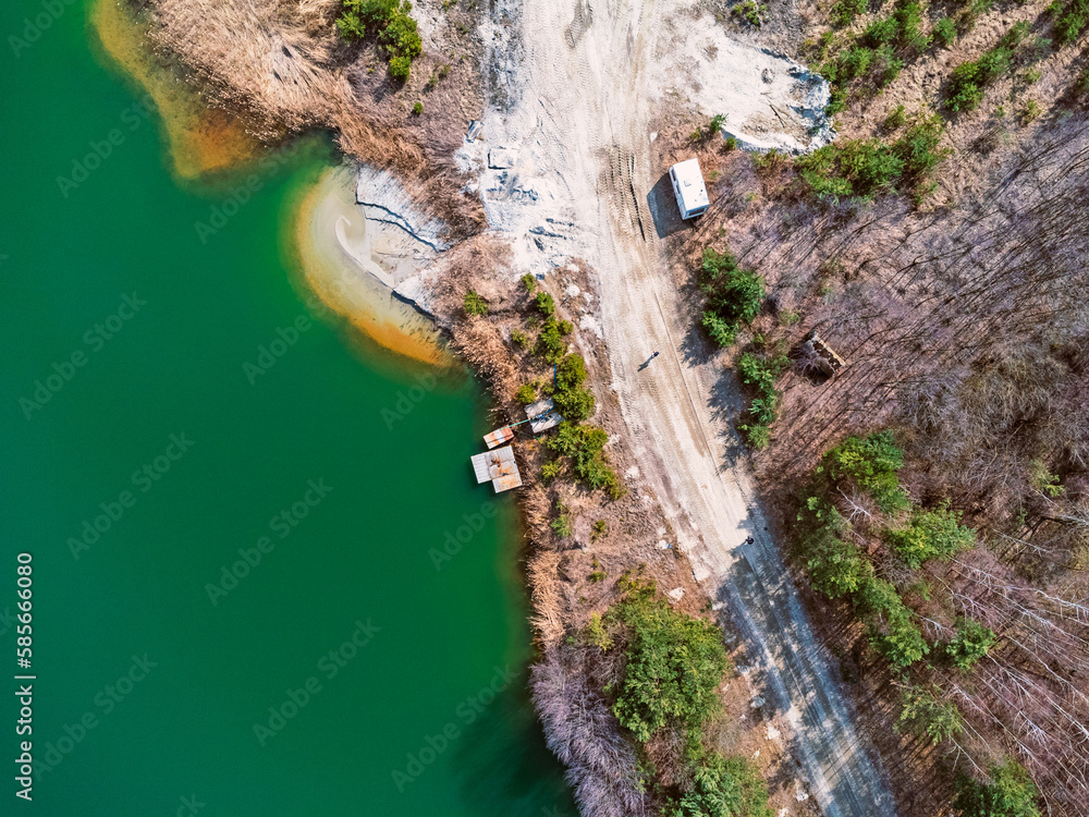 Aerial view landscape. Green water, factory, mining, sand. Photo from a drone.