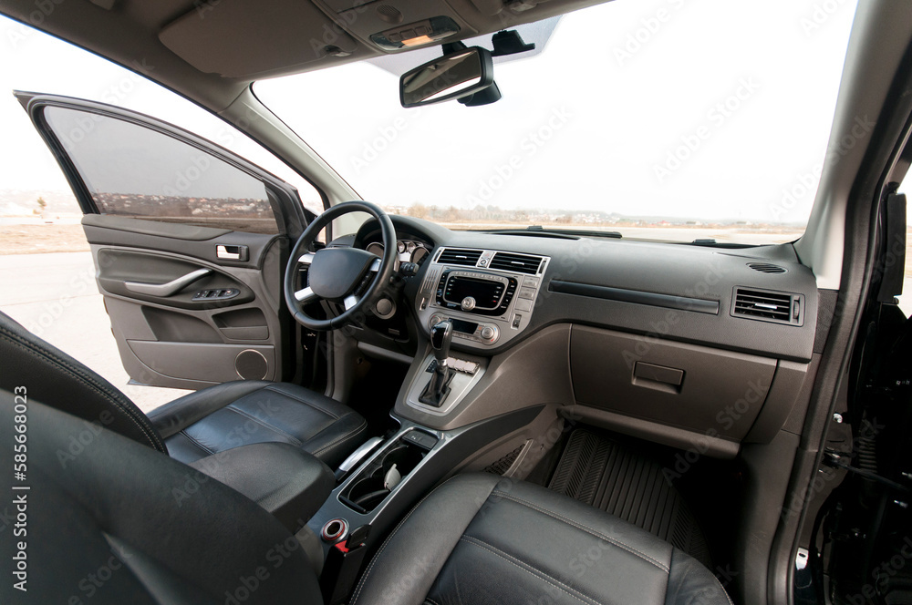 Modern car interior, black perforated leather, aluminum, details controls, leather steering wheel. Modern car interior, black perforated leather, aluminum, details controls, leather steering wheel.