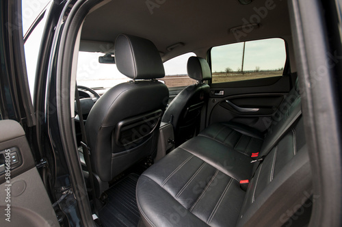 Modern car interior, black perforated leather, aluminum, details controls. © ARTUR
