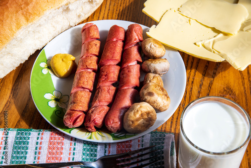 Hot dogs with mushrooms on a white plate...